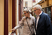 Mature couple looking at shop window