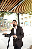 Businessman holding scooter