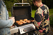 Man preparing meat on barbecue