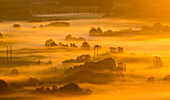 Aerial view of foggy landscape at sunrise