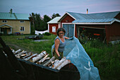 Mature woman stacking firewood