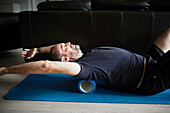 Man stretching and warming up using foam roller
