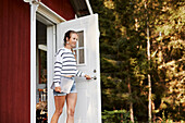 Woman standing at open door