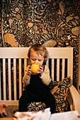 Boy holding orange with cloves