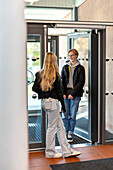 Teenage kids talking in school entrance