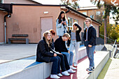 Teenage kids on break in schoolyard