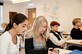 Teenager-Mädchen telefonieren im Klassenzimmer