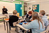 Teenage kids and teacher in classroom