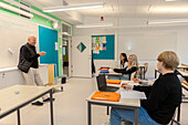 Teenage kids and teacher in classroom