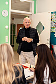 Teenage girls and teacher in classroom