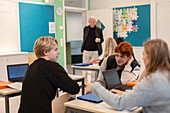 Teenage kids and teacher in classroom