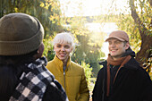 Smiling friends talking outdoors