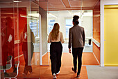 Business people walking in office corridor