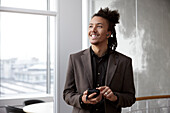 Young businessman talking on phone in office