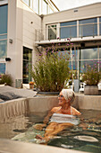 Senior woman relaxing in hot tub