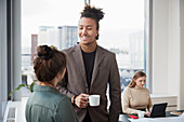 Smiling man talking in office