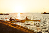 Men kayaking on sunny autumn day