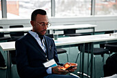 Businessman sitting at desk and using smart phone