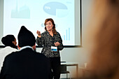 Businesswoman presenting before colleagues during meeting