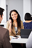 Portrait of young businesswoman sitting at desk