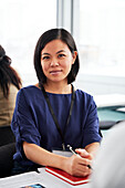 Portrait of young businesswoman sitting at desk