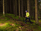 Man running through forest