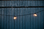 String lights against wooden wall