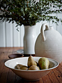 Pears in bowl on table