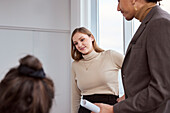Woman standing in office during meeting