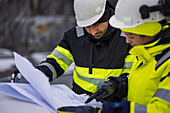 Construction engineers discussing project at construction site