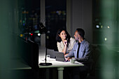 Man and woman working late in office