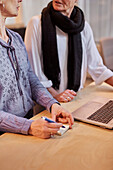 Mid section of women talking in office