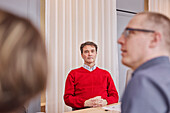 Mature man listening during business meeting
