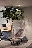 Armchair with footstool in office lobby