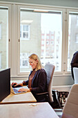 Smiling woman sitting at desk in office