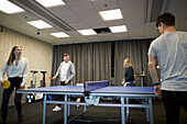 People playing table tennis in office
