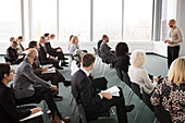 Business people sitting and listening to businessman