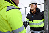 Engineers having handshake at building site