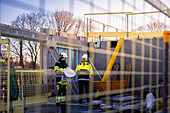 Two engineers looking at blueprints at construction site