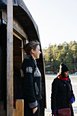 Smiling woman standing in front of sauna