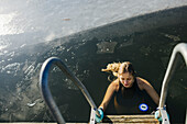 Woman swimming in lake at winter