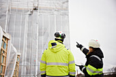 Engineers talking at building site