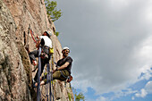 View of rock climbers on rock face