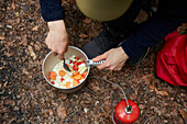 Man's hands preparing food outdoors