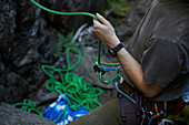 Mittelteil eines Bergsteigers, der ein Seil in der Hand hält