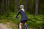 Rear view of female cyclist