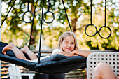 Smiling girl relaxing on hammock