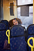 Young woman sitting in bus