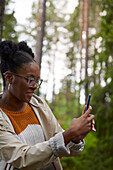 Young woman taking photo with cell phone