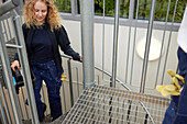 Young woman walking up staircase